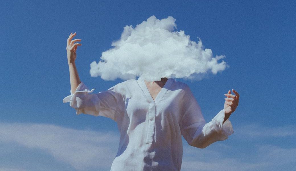 head in cloud with blue sky in background