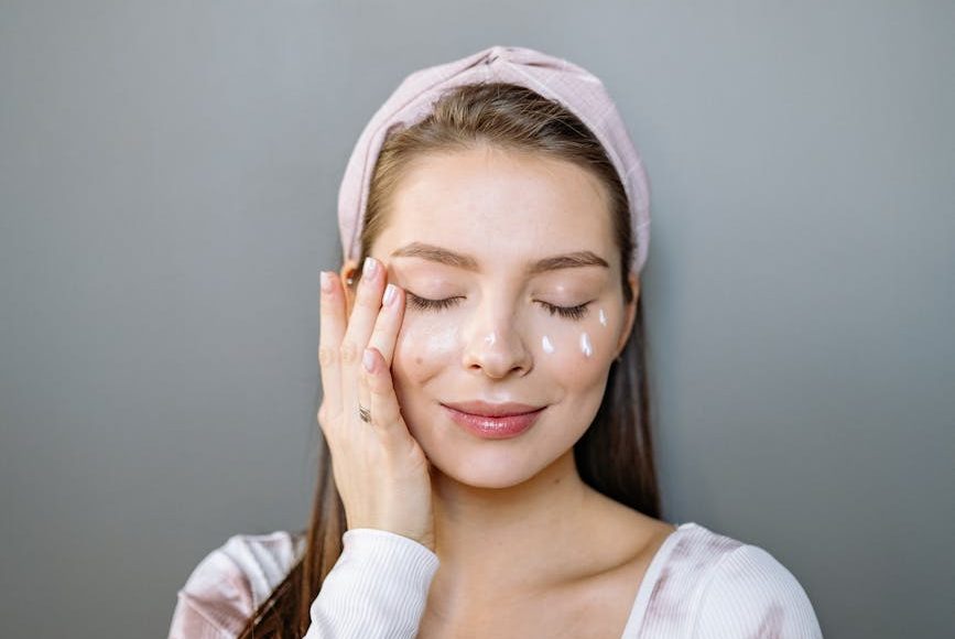 photo of a woman putting cream on her face