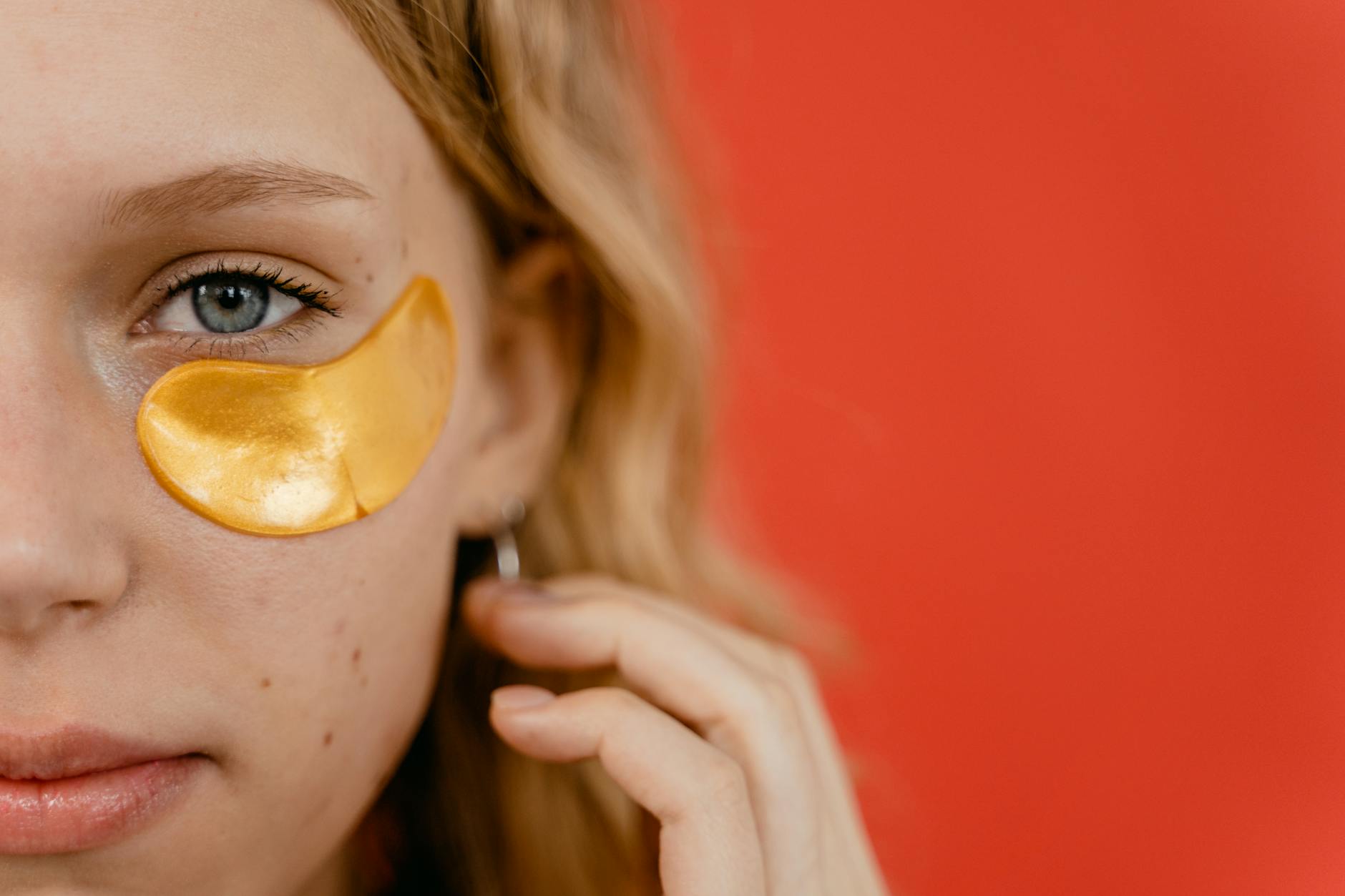 woman with yellow under eye patch