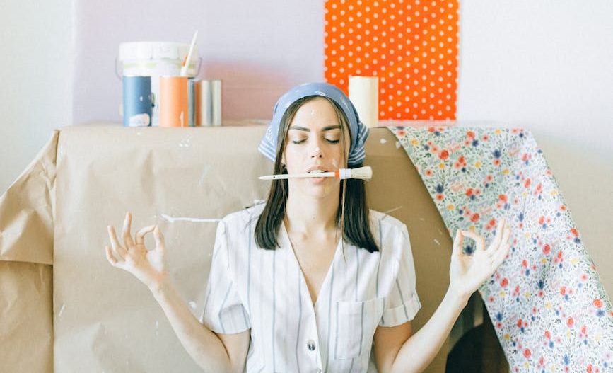 woman in white button up shirt and blue denim jeans sitting on bed
