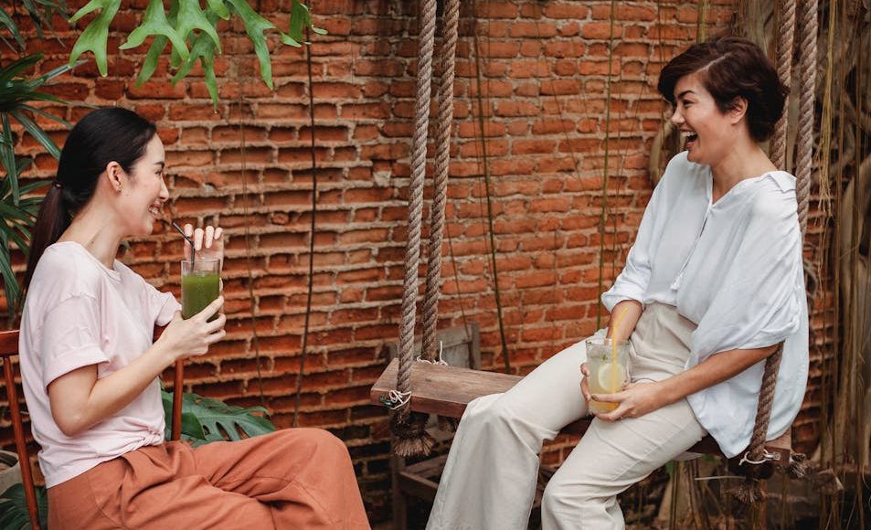 happy asian friends resting on terrace
