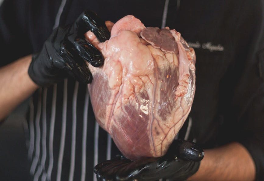 man holding raw meat