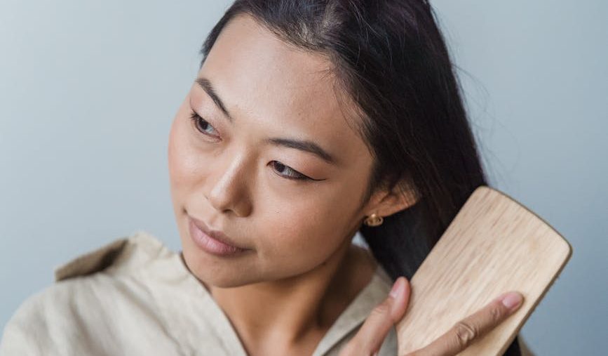 a woman brushing her long hair